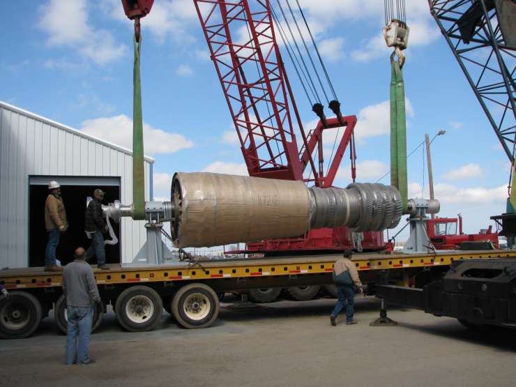 Crane lifts turbine rotor to be stored in our warehouse Crane lifting turbine rotor